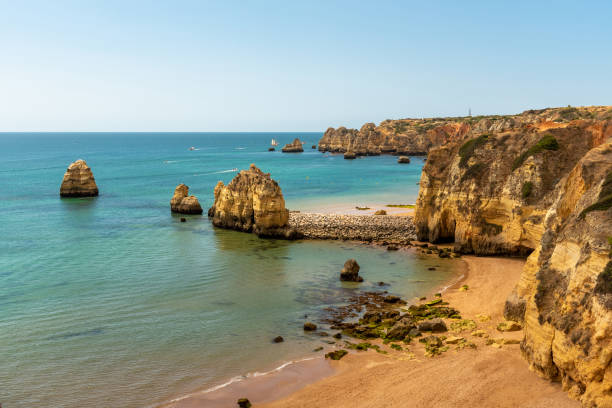 Beach and coastline at Lagos, Algarve, Portugal Sandy beach at Lagos, Algarve, Portugal lagos portugal stock pictures, royalty-free photos & images