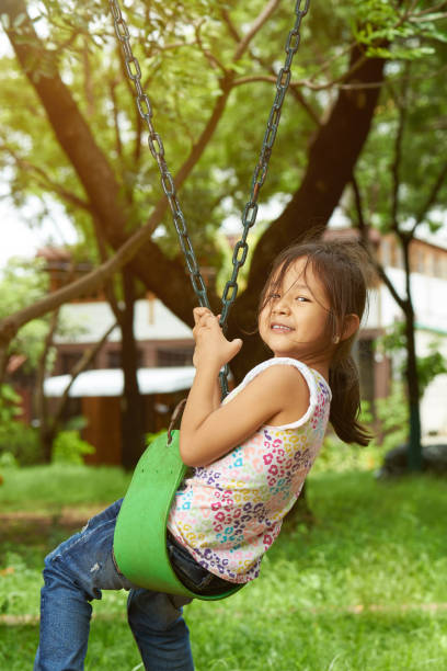 istock Girl kid playing in park 1154642622