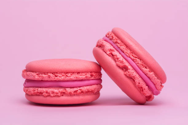 istock Two pink macaron cookies on a pink background. 1154644756