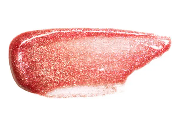 Lip gloss sample isolated on white. Smudged red lipgloss.