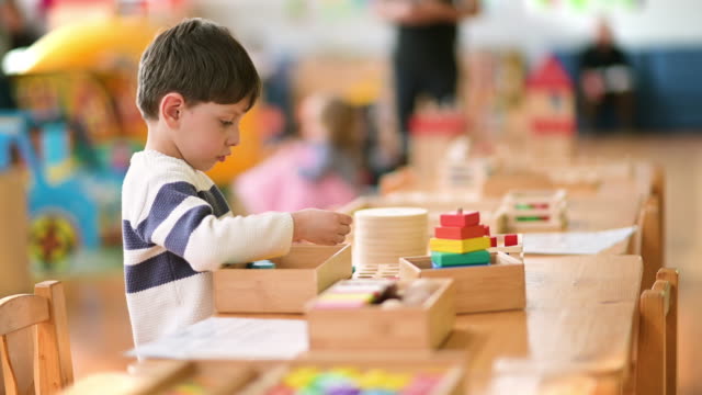 Cute Little Boy Playing at Kindergarten with Construction Toy