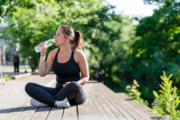 istock A woman is drinking a refreshing cucumber drink after her exercise 1154650338
