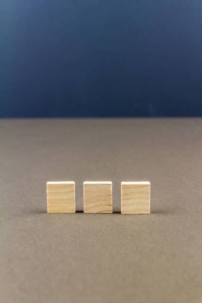 istock Three children wooden blocks in line, portrait 1154651312