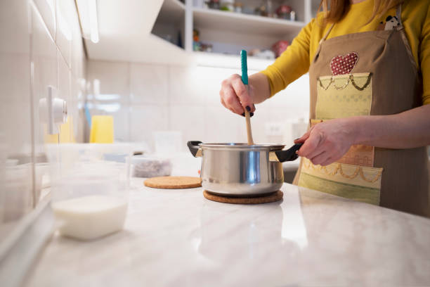 istock Close up of woman hands working at a kitchen counter 1154651449