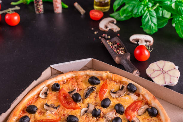 istock Tasty fresh hot pizza against a dark background 1154654053