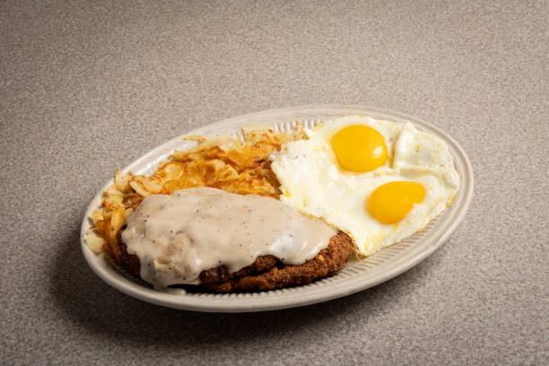American Diner food chicken fried steak plate of chicken fried steak with eggs and hash browns steak and eggs breakfast stock pictures, royalty-free photos & images