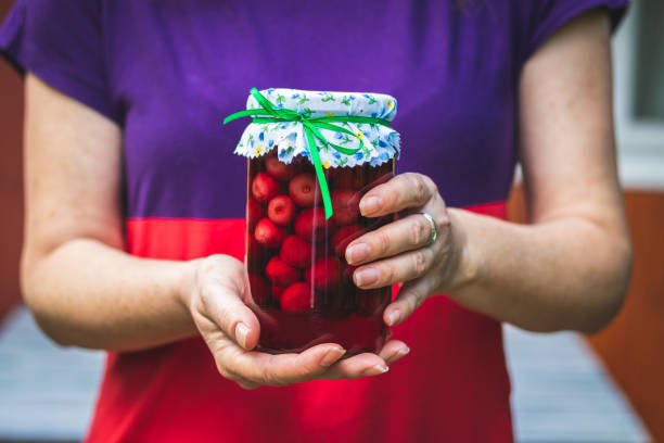 istock Woman holding cherry fruit compote in hands. 1154661546