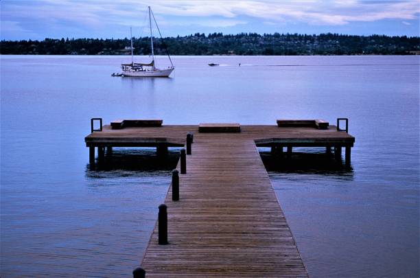 istock Seattle from Kirkland Waterfront Park with Passing Sailboat and Waterskiier on Tranquil Cloudy Summer Morning in Kirkland Washington USA on Lake Washington 1154662898