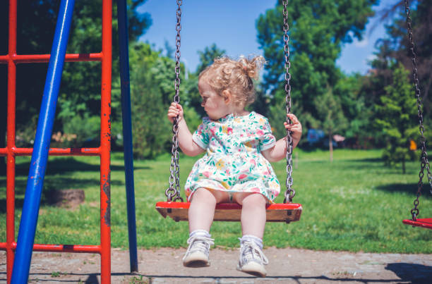 istock Baby girl on swing 1154672158