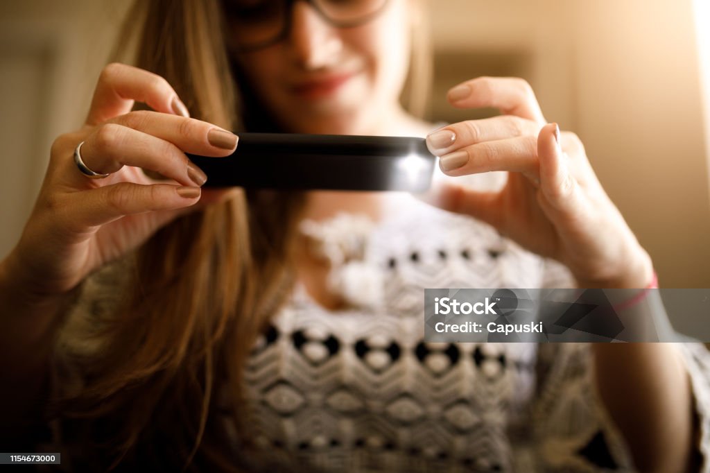 Woman depositing check by phone Woman depositing check by phone. Mobile Phone Stock Photo