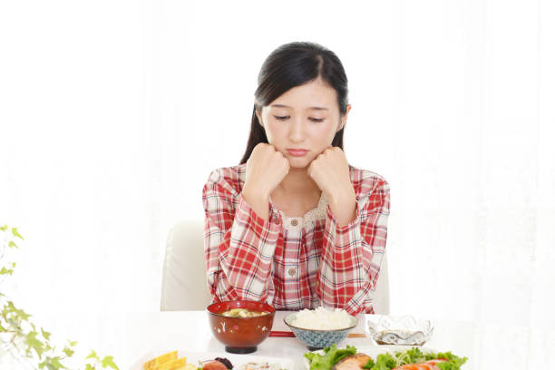 istock Young woman eating food 1154680618