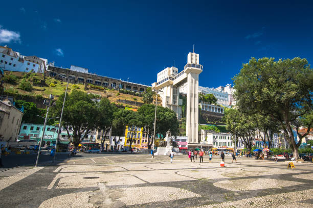 Photo of the Lacerda Elevator, Salvador, Bahia, Brazil. Salvador, Bahia, Brazil - June 16, 2017: Photo of the Lacerda Elevator in Salvador, Bahia. Located next to the model market, the elevator is widely used daily by residents and tourists. In the picture of a hot sunny day made on a hot day even in winter, we can see several people in their daily routine and some tourists. lacerda elevator stock pictures, royalty-free photos & images