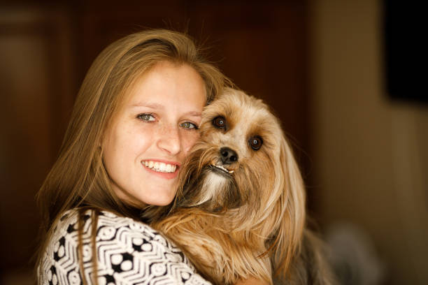 istock Woman hugging her fluffy dog 1154682472