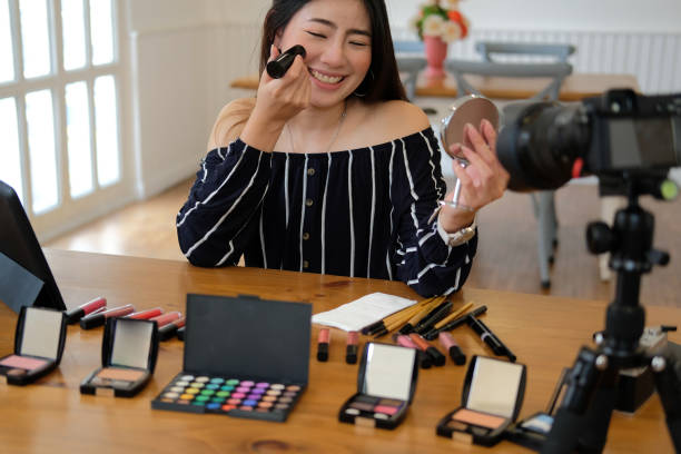 istock beauty blogger live broadcasting cosmetic makeup tutorial on social media. 1154684446