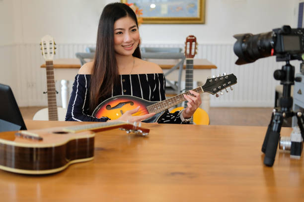 istock blogger live broadcasting music instrument tutorial on social media. vlogger recording online vlog video. 1154684452