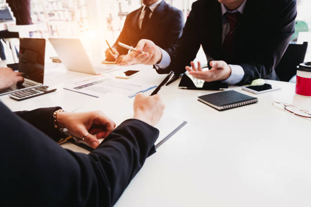 istock Business people analyzing investment graph meeting brainstorming and discussing plan in meeting room, investment concept 1154685358