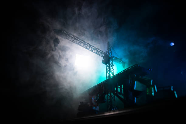 istock Abstract Industrial background with construction crane silhouette over amazing sunset sky. Tower crane against the evening sky. Industrial skyline 1154686831
