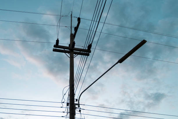 istock Silhouetted electric pole in sky background 1154689361