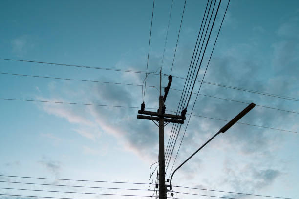 istock Silhouetted electric pole in sky background 1154689373