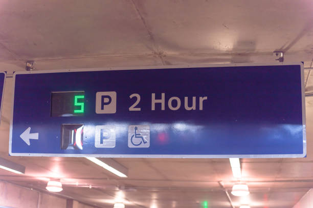 istock Signboard with traffic directions and LED display available parking space 1154692607