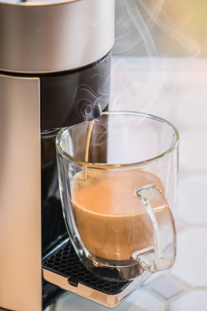 istock Coffee maker pouring into glass mug 1154692677