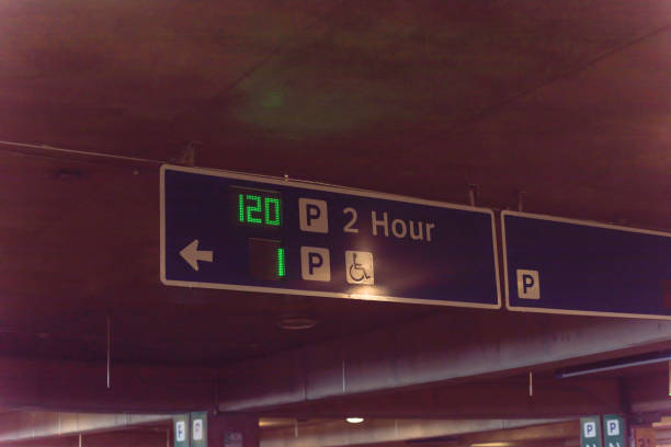istock Signboard with traffic directions and LED display available parking space 1154692685