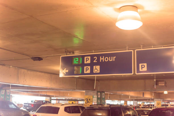 istock Signboard with traffic directions and LED display available parking space 1154692690