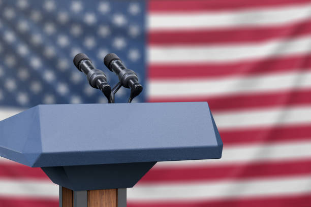 Flag of the United States at a press conference with microphones Podium lectern with two microphones and United States flag in background debate stock pictures, royalty-free photos & images