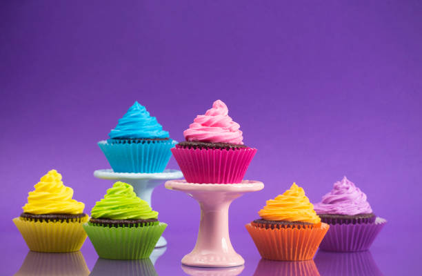 istock Rainbow Colored Frosted Chocolate Cupcakes set for a Party 1154695932