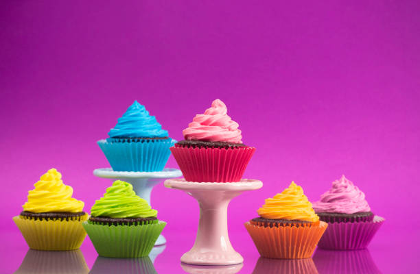 istock Rainbow Colored Frosted Chocolate Cupcakes set for a Party 1154695968