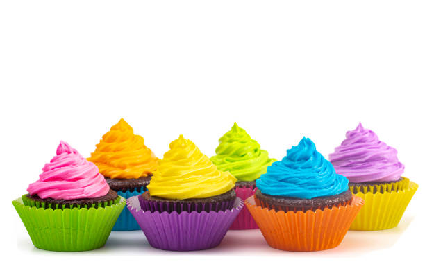 istock Rainbow Colored Frosted Chocolate Cupcakes Isolated on a White Background 1154695984