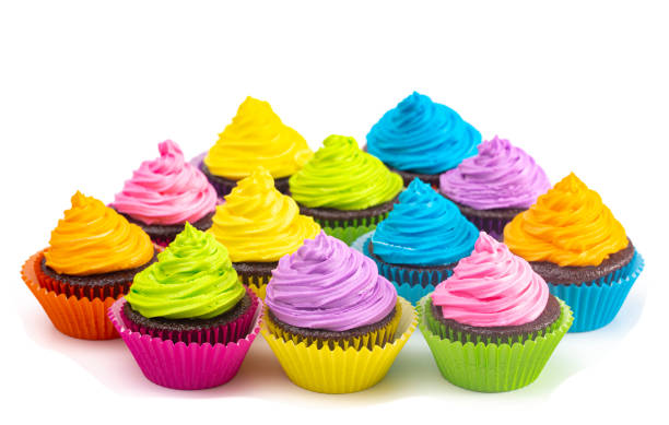 istock Rainbow Colored Frosted Chocolate Cupcakes Isolated on a White Background 1154696006