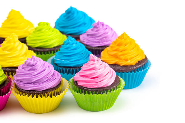 istock Rainbow Colored Frosted Chocolate Cupcakes Isolated on a White Background 1154696009