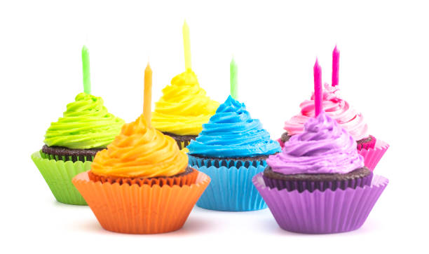 istock Rainbow Colored Frosted Chocolate Cupcakes Isolated on a White Background 1154696014