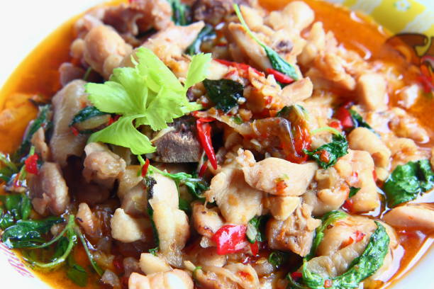 istock Spicy fried chicken with basil leaves 1154701060