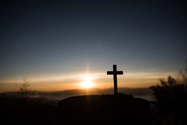 istock Silhouette of catholic cross and sunrise 1154702522