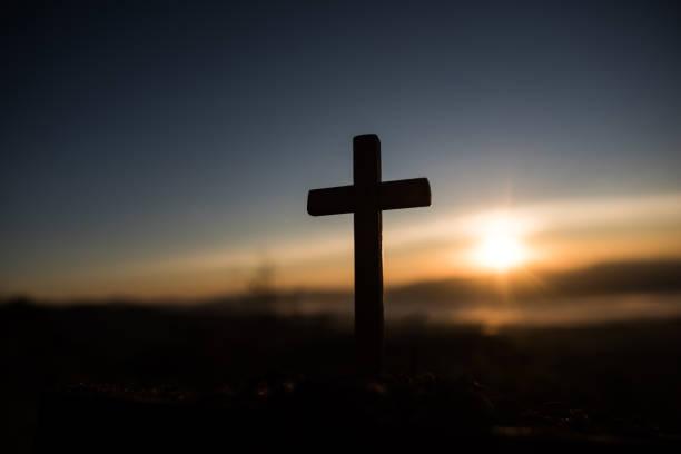 istock Silhouette of catholic cross and sunrise 1154702533