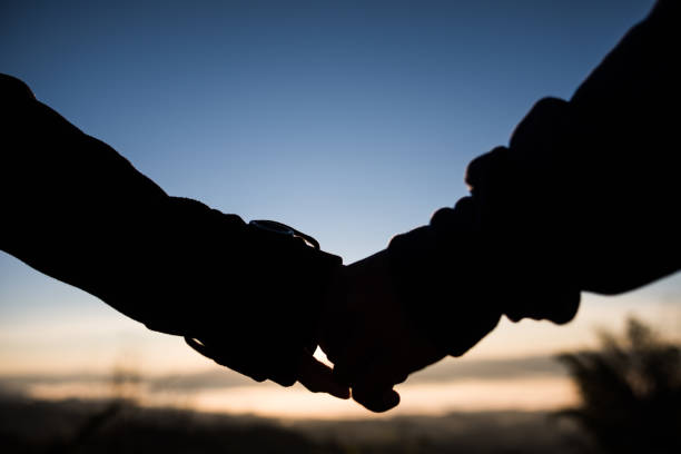 istock Couple holding hands with love 1154702539