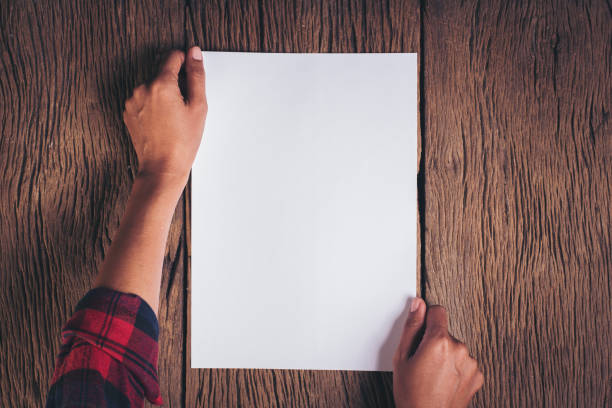 istock Top view Hand with blank white paper 1154703985