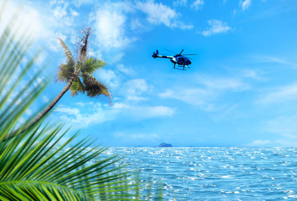 Flying commercial helicopter over tropical island