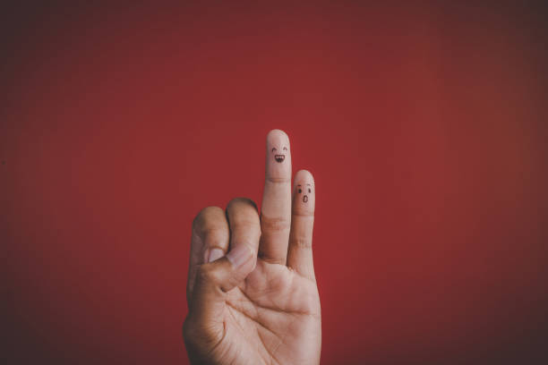 istock Finger with emotion on red background 1154705058