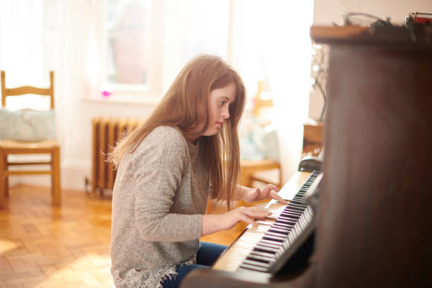 istock teenager at the piano 1154714778