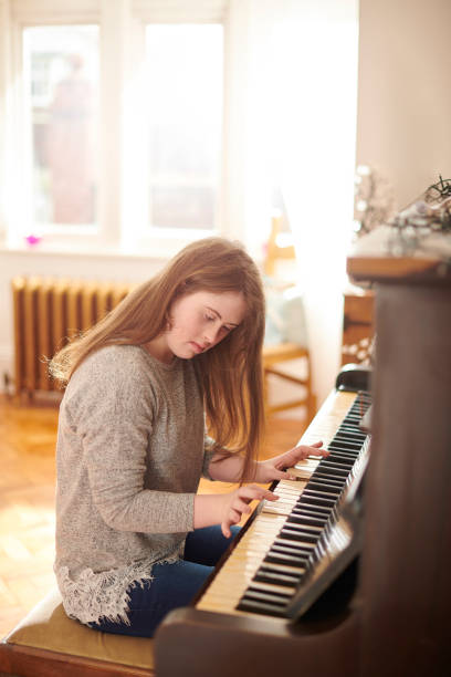 istock teenager at the piano 1154714893