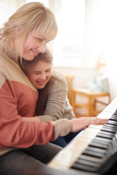 istock mother and daughter playing piano 1154714952
