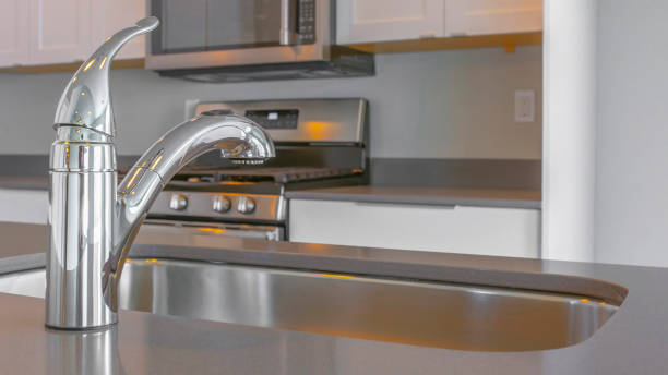 istock Panorama Modern kitchen interior with faucet and sink on the glossy countertop 1154715033