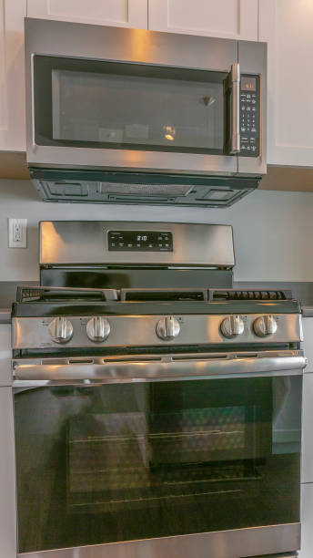 istock Panorama frame Range and wall mounted microwave inside the modern kitchen of a new house 1154715041