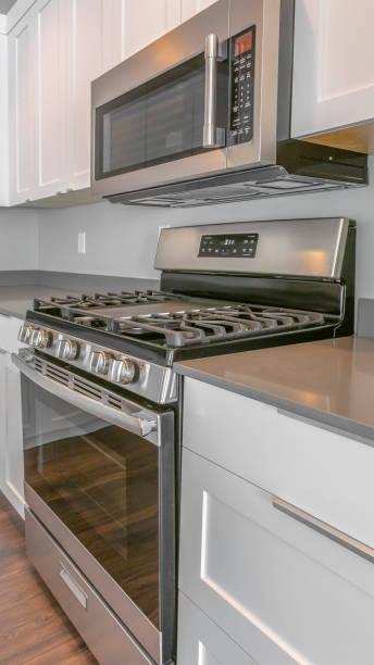 istock Panorama Modern kitchen interior of a house with shiny range and wall mounted microwave 1154715045