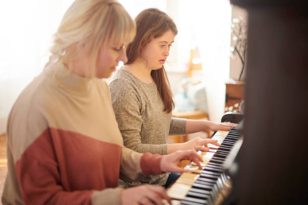 istock mother and daughter playing piano 1154715206