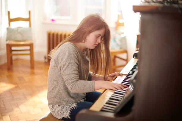 istock teenager at the piano 1154715227