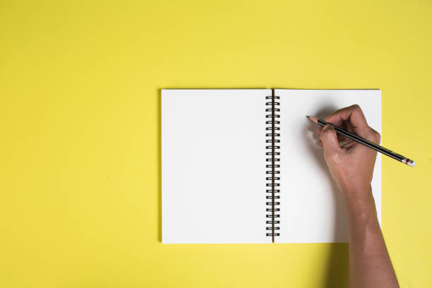 Woman's hands with blank notebook stock photo